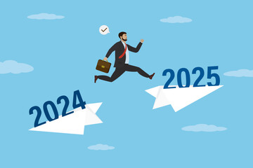 Obraz premium Smart businessman changing of direction and jump on paper plane with 2025 year. Starting new 2025 year, celebrating. Future forecasting, hope of new opportunities and goals