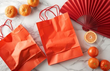 Red gift bags oranges, Chinese fans on white marble table. Lunar New Year decorations. Minimalist design. Celebration, prosperity concept for 2025 holiday season. Beautiful art pieces for festive 