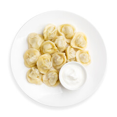 Boiled dumplings with meat and sour cream, top view, on a white background, isolated.