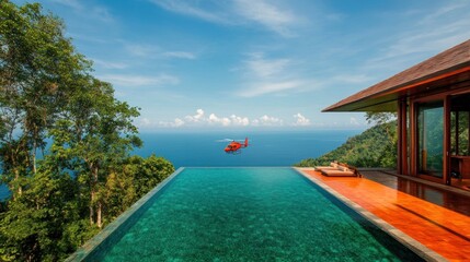 Fototapeta premium Scenic infinity pool overlooking the ocean with a helicopter in the sky.