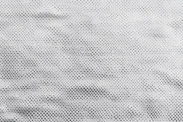 A close-up view of a white sports jersey fabric texture.