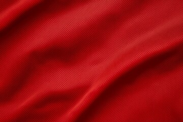 Vibrant red fabric texture of a sports football shirt.