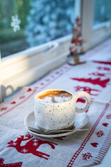 Close up of Hot coffee latte with latte art milk foam in cup mug with Xmas decors and Xmas tree baubles on wood desk Celebrating Merry Christmas and New year,Merry x-mas