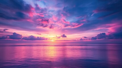 Fototapeta premium A breathtaking view of the morning sunrise over a calm ocean, with the sky filled with warm colors.