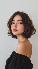 Beautiful woman with bob cut hair posing in front of white background
