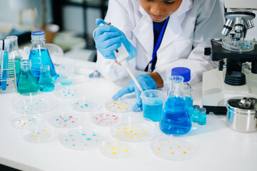 Fototapeta premium Young scientists conducting research investigations in a medical laboratory, a researcher in the foreground
