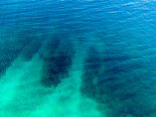 Aerial view of clear turquoise ocean water.