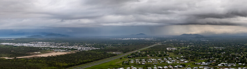 Storms over a mountain range and city in the distance, Townsville