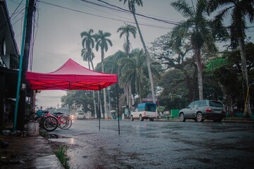 Rainy scene in bocas del toro, beautiful islands in northern panama. View of main park and street during harsh rain shower.