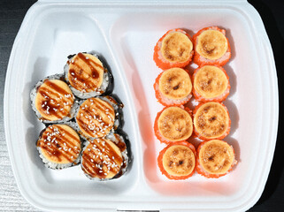 Japanese sushi in a white shipping container. View from above