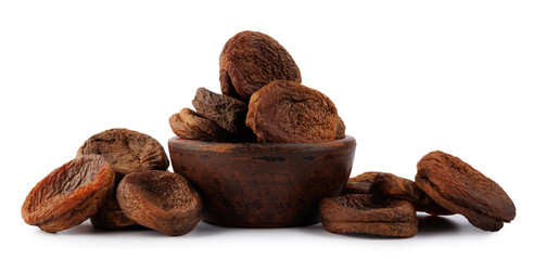 Mountain dried apricots in a cup and in bulk isolated on a white background. Delicious and healthy dried apricots.
