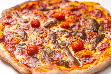 Homemade freshly baked pepperoni pizza on a white background. Close-up, chosen focus.