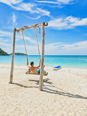 Sunny day at Samae San Island in Thailand with tranquil waters and bright blue skies