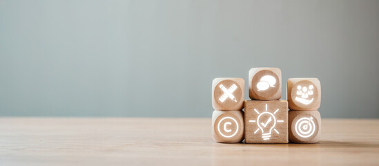 Wooden blocks with business icons representing corporate identity on a minimalist background, symbolizing innovation and strategy.