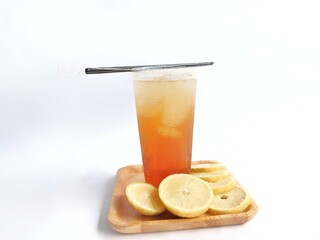 iced lemon tea packaged in a plastic cup on a white background