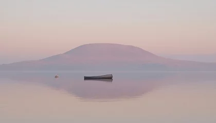 Fototapeten Serene dawn landscape a lone boat rests on calm water, reflecting a hazy mountain under a pastel sky. © gede