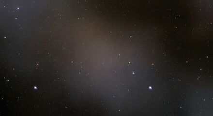 Obraz premium Cosmic Dust and Distant Stars: A mesmerizing abstract image of cosmic dust and distant stars against a dark background. The image evokes a sense of wonder and mystery.