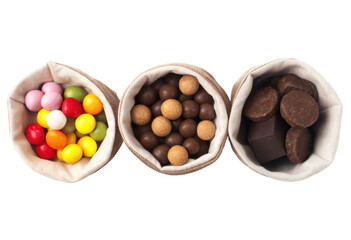 Three fabric bags filled with various sweets isolated with transparent background
