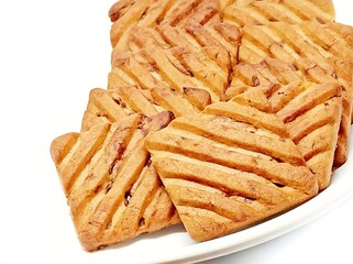cookies ready to be served in a plate.fresh chocolate chip cookies spread on a white plate to be served.choco chip cookies isolated over white background.cookie image for display isolated over white