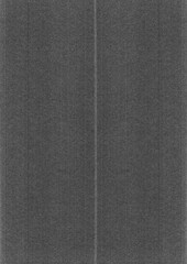 Fototapeta premium Black and white, gray paper texture background with vertical lines. The paper is folded into two parts. Top view of a textured, dark gray cardboard surface.