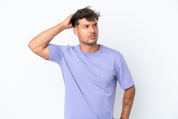 Young caucasian handsome man isolated on white background having doubts while scratching head