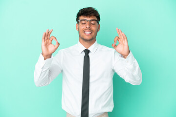 Business caucasian man isolated on blue background in zen pose