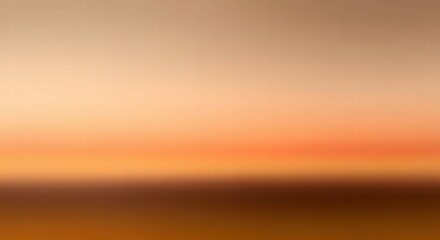Obraz premium Sunrise Horizon: A soft and ethereal gradient of orange and brown hues captures the essence of a peaceful sunrise, with a gentle horizon blending into the sky. 