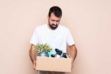 Man holding a box and moving in new home over isolated background