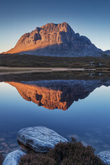 Majestic mountain reflected in calm lake at sunrise
