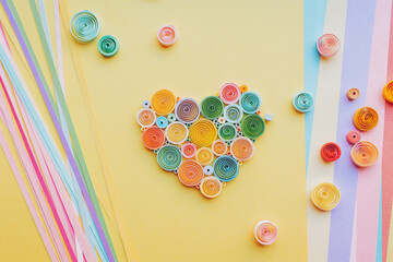 Quilling paper heart. Happy valentine day. Hand made of paper quilling technique. Handicraft at home. Hobby, home office. Heart from colored paper ribbons.  Quilling Valentines Day Ornament