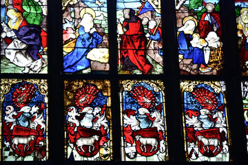 Mosaic colored bright stained glass window of the church with scenes from the lives of Christian...
