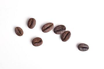 Many roasted coffee beans isolated on white background, top view