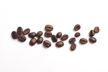 Many roasted coffee beans isolated on white background, top view