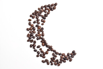 Top view of crescent shaped coffee beans isolated on white background.