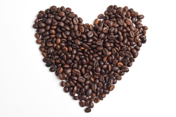 Roasted coffee beans arranged in heart shape isolated on white background.