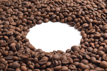 Frame of roasted coffee beans on white background, top view