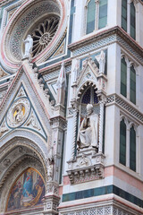 Florence, Italy - November 28, 2024: Close-up of architectural details on Florence Duomo (Cathedral of Santa Maria del Fiore), showcasing intricate Gothic design and Renaissance craftsmanship.