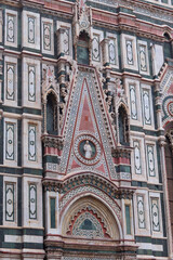 Florence, Italy - November 28, 2024: Close-up of architectural details on Florence Duomo (Cathedral of Santa Maria del Fiore), showcasing intricate Gothic design and Renaissance craftsmanship.