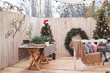 New Year and Christmas outdoor decorations. Christmas tree, wreath and gifts. Winter holidays and celebrations.