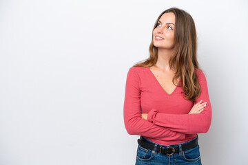 Young caucasian woman isolated on white background looking up while smiling