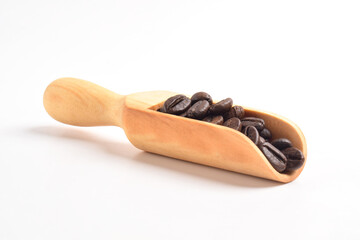 Coffee beans on wooden scoop isolated on white background