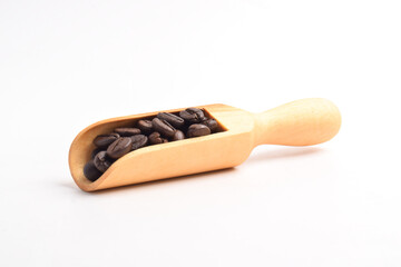 Coffee beans on wooden scoop isolated on white background