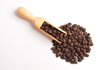 Roasted coffee beans in wooden spoon isolated on white background. Top view