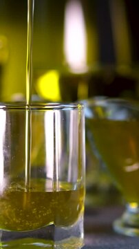 Crane shot of olive oil is being poured into empty beaker on grey background Abstract anti-aging cosmetics ingredients formulating concept