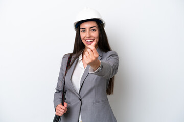 Young architect caucasian woman with helmet and holding blueprints isolated on white background...