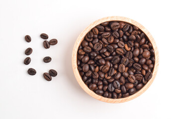 Coffee beans in wooden bowl isolated on white background. Top view. flat lay
