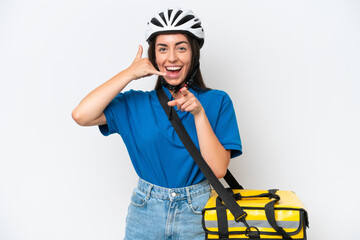 Young caucasian woman with thermal backpack isolated on white background making phone gesture and pointing front