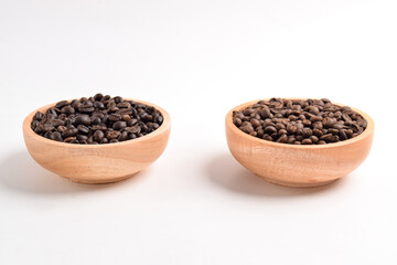 Roasted coffee bean in wooden bowl isolated on white background.