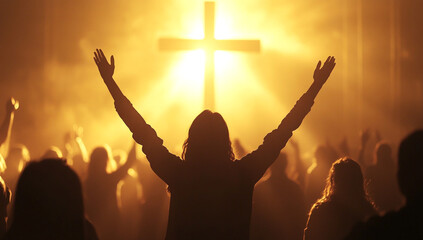 A group of people in a church, hands raised to heaven with crosses on the wall behind them, faces and arms illuminated by warm light from the windows.