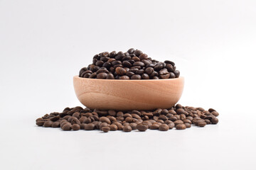 Roasted coffee bean in wooden bowl isolated on white background.
